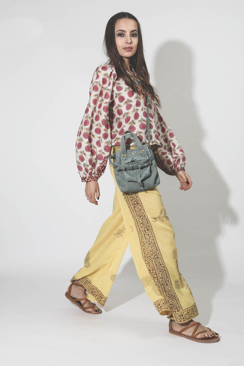 Pantalon en voile de coton imprimé jaune Alix of Bohemian. Porté avec une blouse à fleurs.