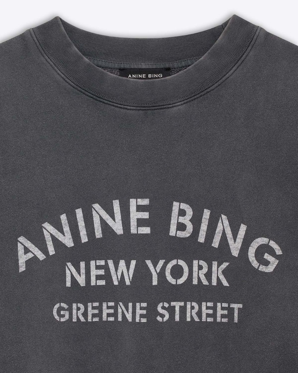 Sweat-shirt Miles NY Anine Bing en coton noir délavé. Détail de la sérigraphie blanche ANINE BING NEW YORK GREENE STREET.