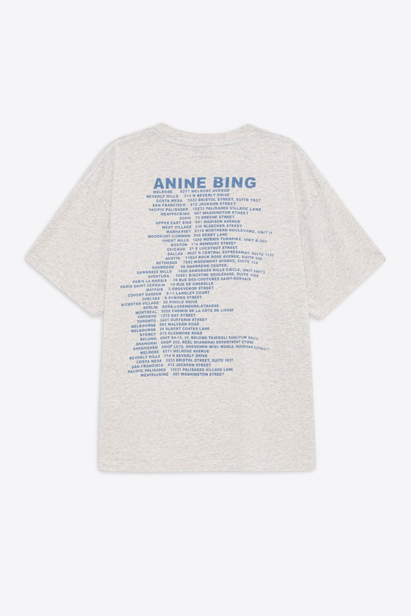 Tee-shirt Cade Wave Anine Bing en jersey gris clair chiné et logo stylisé Anine Bing bleu sur le poitrine et sérigraphie bleu dans le dos.
