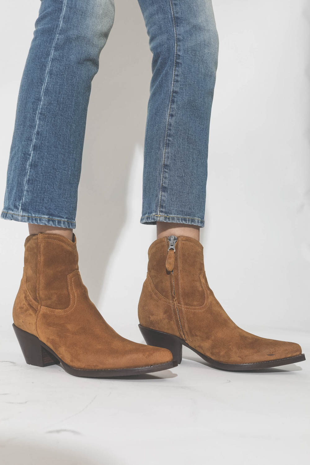 Boots santiags Cowboy en cuir suédé camel R13. Porté avec un jeans court bleu ciel.