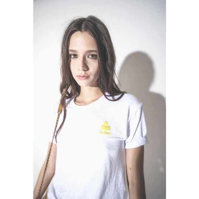 T-shirt Koldia Isabel Marant Étoile en lin blanc, logo jaune flocké au-dessus de la poitrine, porté de face. Détail du logo jaune fluo.