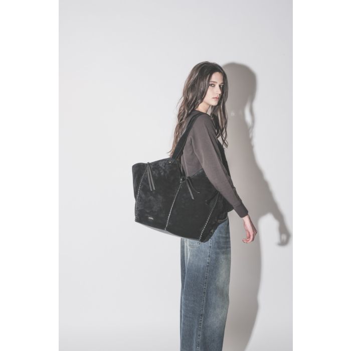 Sac Cabas Tampa Isabel Marant en cuir suédé noir, porté de profil à l'épaule.