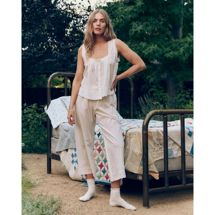 Top à bretelles Eyelet The Great en coton et dentelle crème, porté de face avec un pantalon assorti.