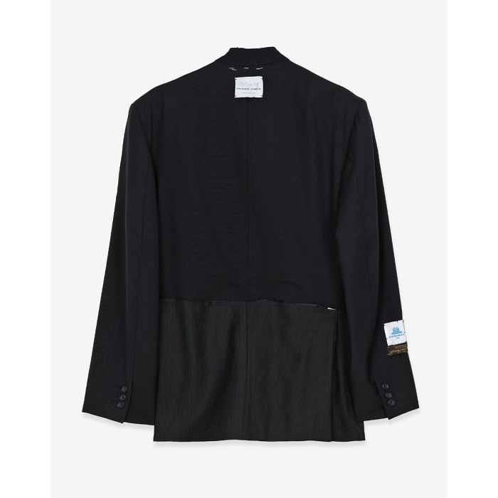 Blazer customisée par Yekaterina Ivankova Upcycling en laine froide Noire. Détail doublure de la poche blanche. Vue de dos.