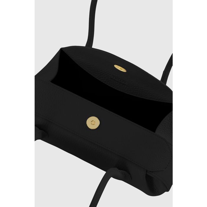 Sac Mini Oyster Yuzefi en cuir grainé noir, mini sac baguette porté épaule au design contemporain. Détail de la fermeture à rabat aimantée sur le dessus du sac.