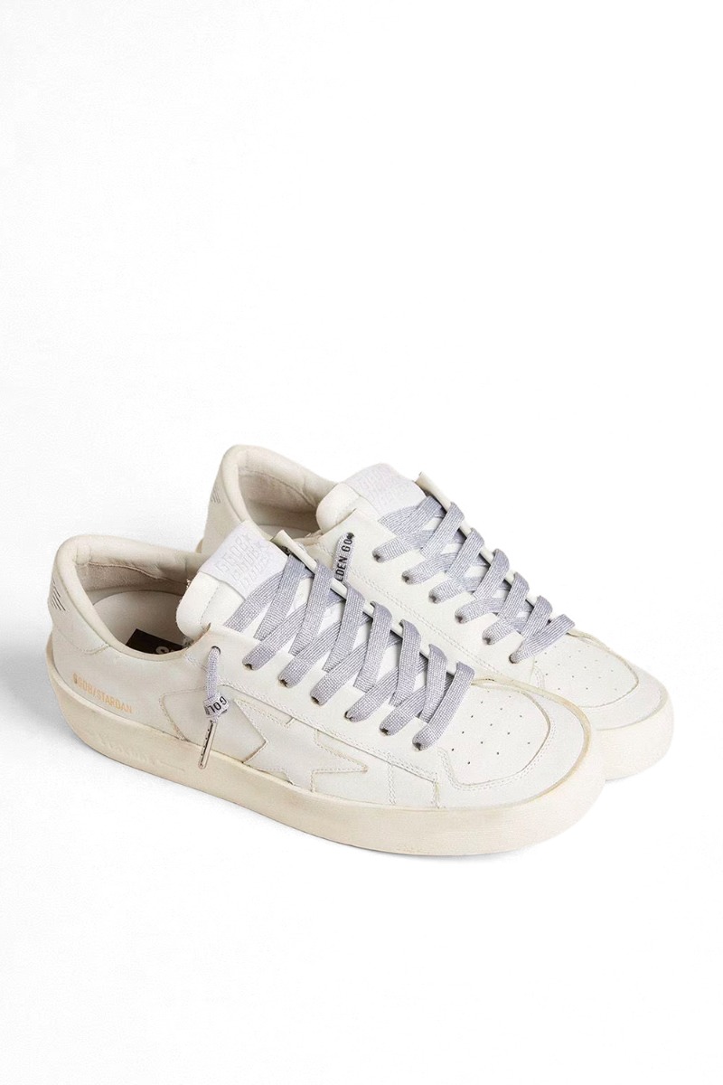 Produit Lacets Golden Goose en lurex argent, logo noir contrasté. Vue portée sur des sneakers en cuir blanc. 