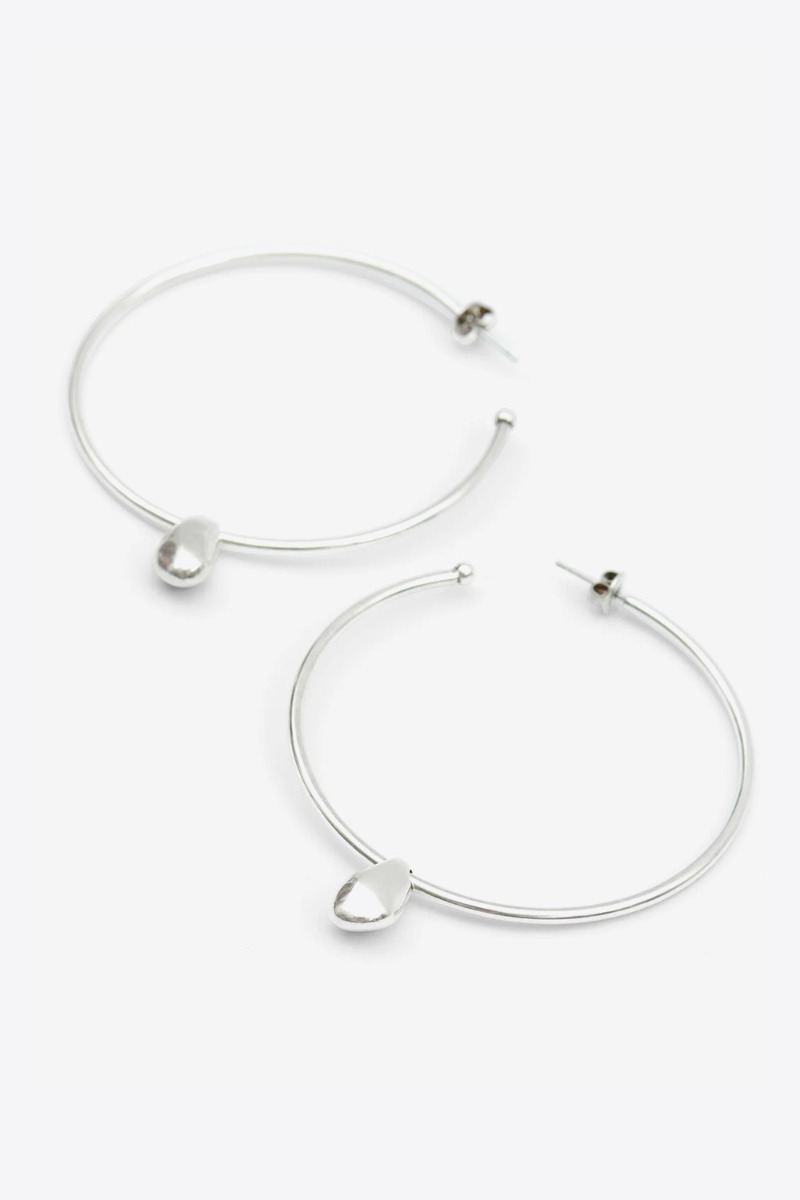 Produit Grandes créoles Shiny Day Isabel Marant en laiton argenté et pendentif goutte. Profil.