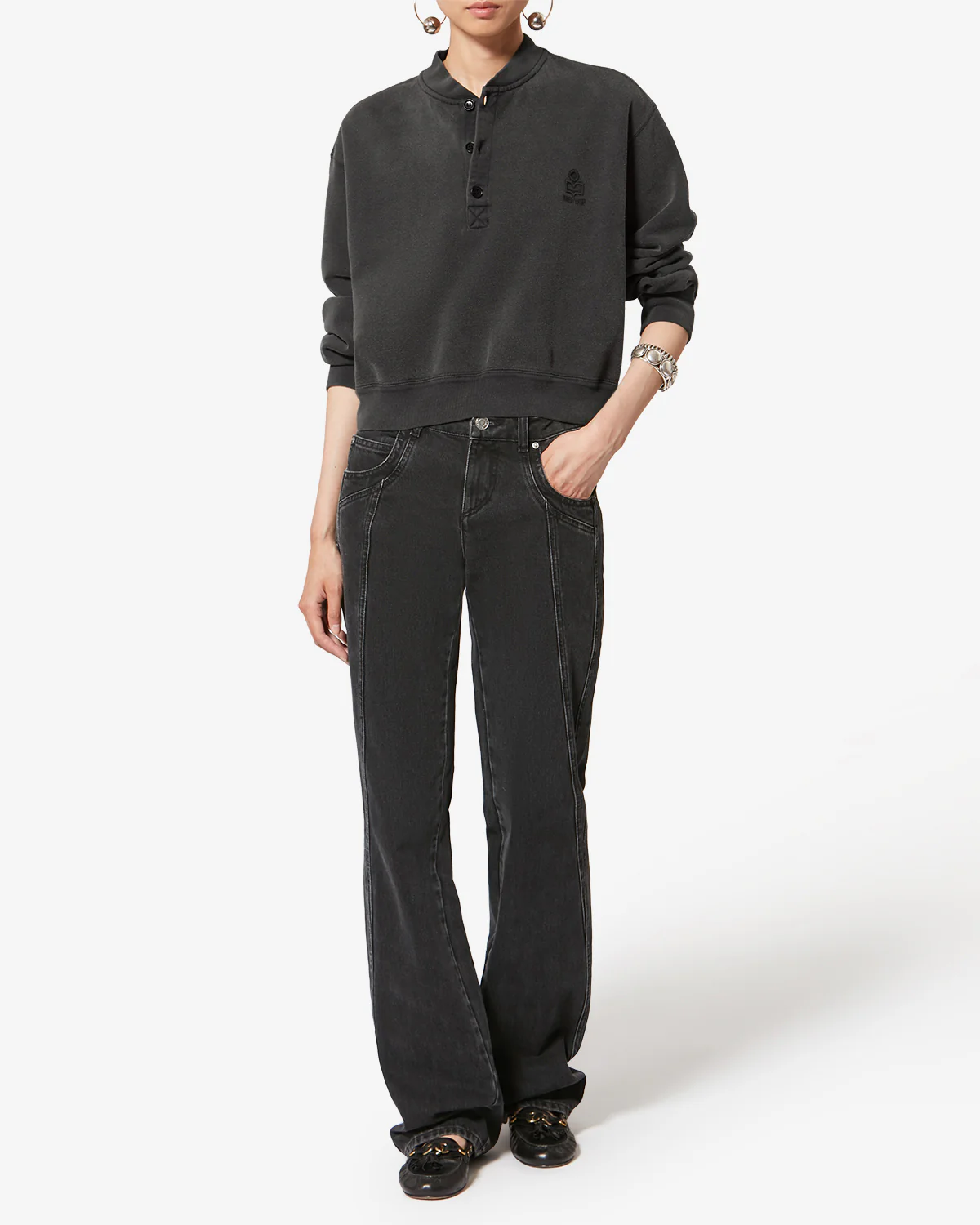 Sweatshirt court Simony Isabel Marant Etoile en coton noir d&eacute;lav&eacute;. Encolure boutonn&eacute;es et logo brod&eacute; &laquo; Marant &raquo; ton sur ton sur la poitrine. Port&eacute; avec un jean noir.