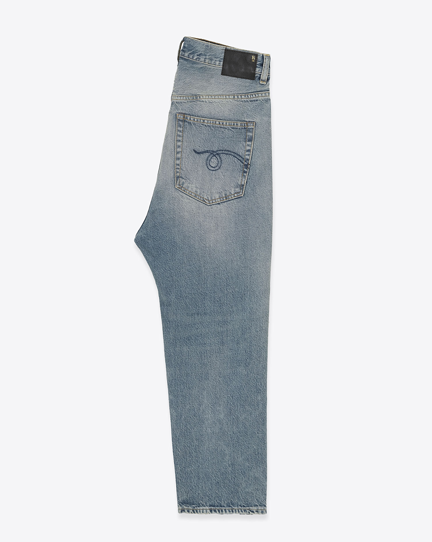 Jean Tailored Drop R13 en denim de coton délavé. Vue profil. 
