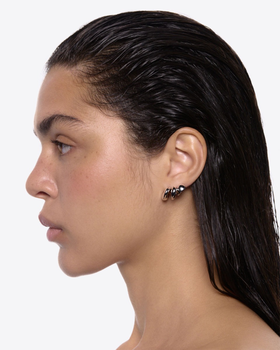 Boucles d'oreilles Coil Crawler Maria Black en argent recyclé. Portées de profil.