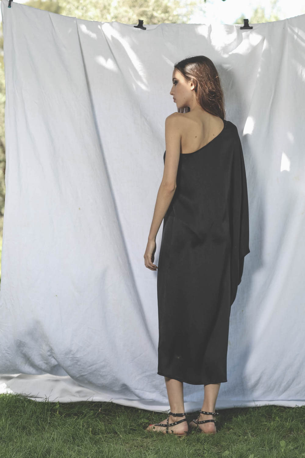 Robe longue en satin noir asymétrique une manche Rowan Anine Bing. Porté dos profil. 