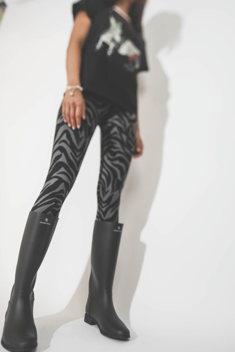 Leggings imprimé zèbre gris et noir Blake Anine Bing. Porté avec des bottes. 