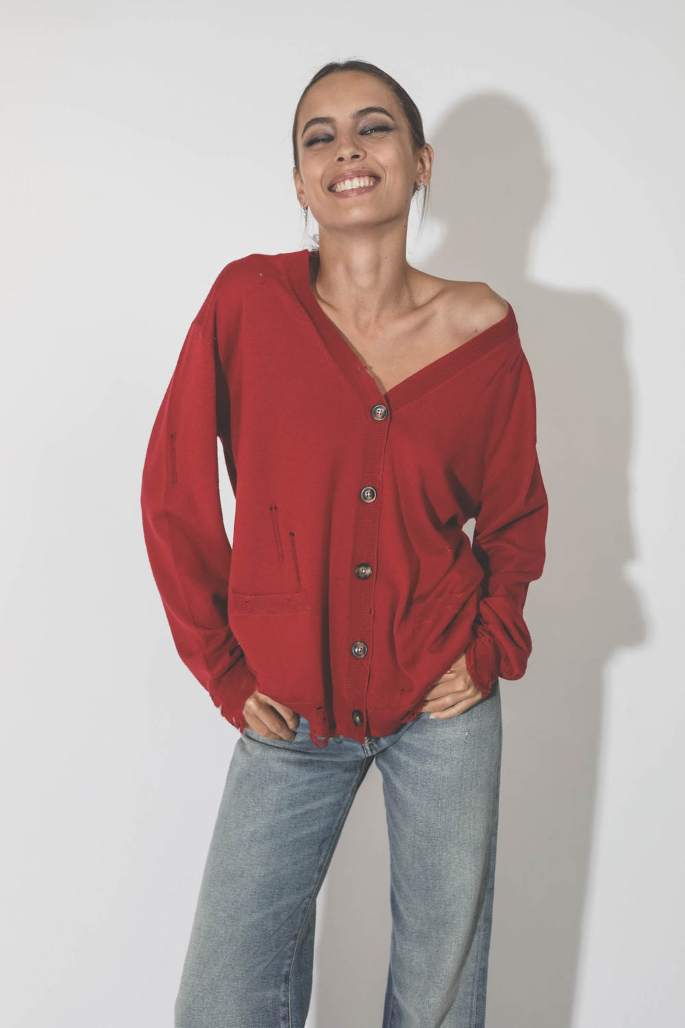 Gilet col V démaillé en 100% cachemire rouge R13. Détail des boutons corne.