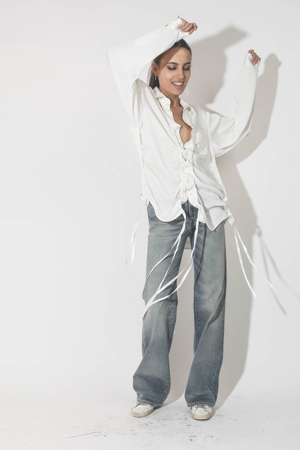 Chemise blanche plissée Boyfriend R13. Porté avec un jean bleu taille haute évasé.