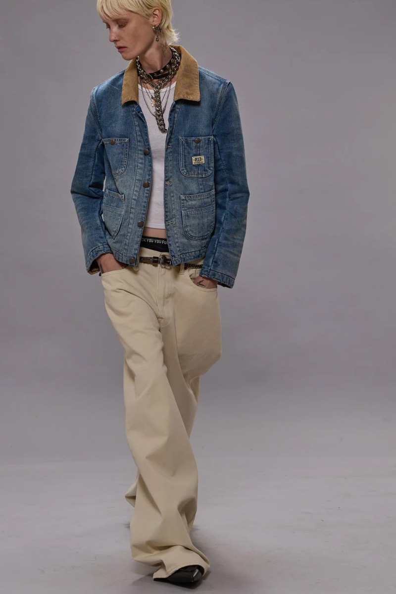 Veste Cropped Chore R13 en denim bleu Calli Blue. Portée de face avec un jean beige. 