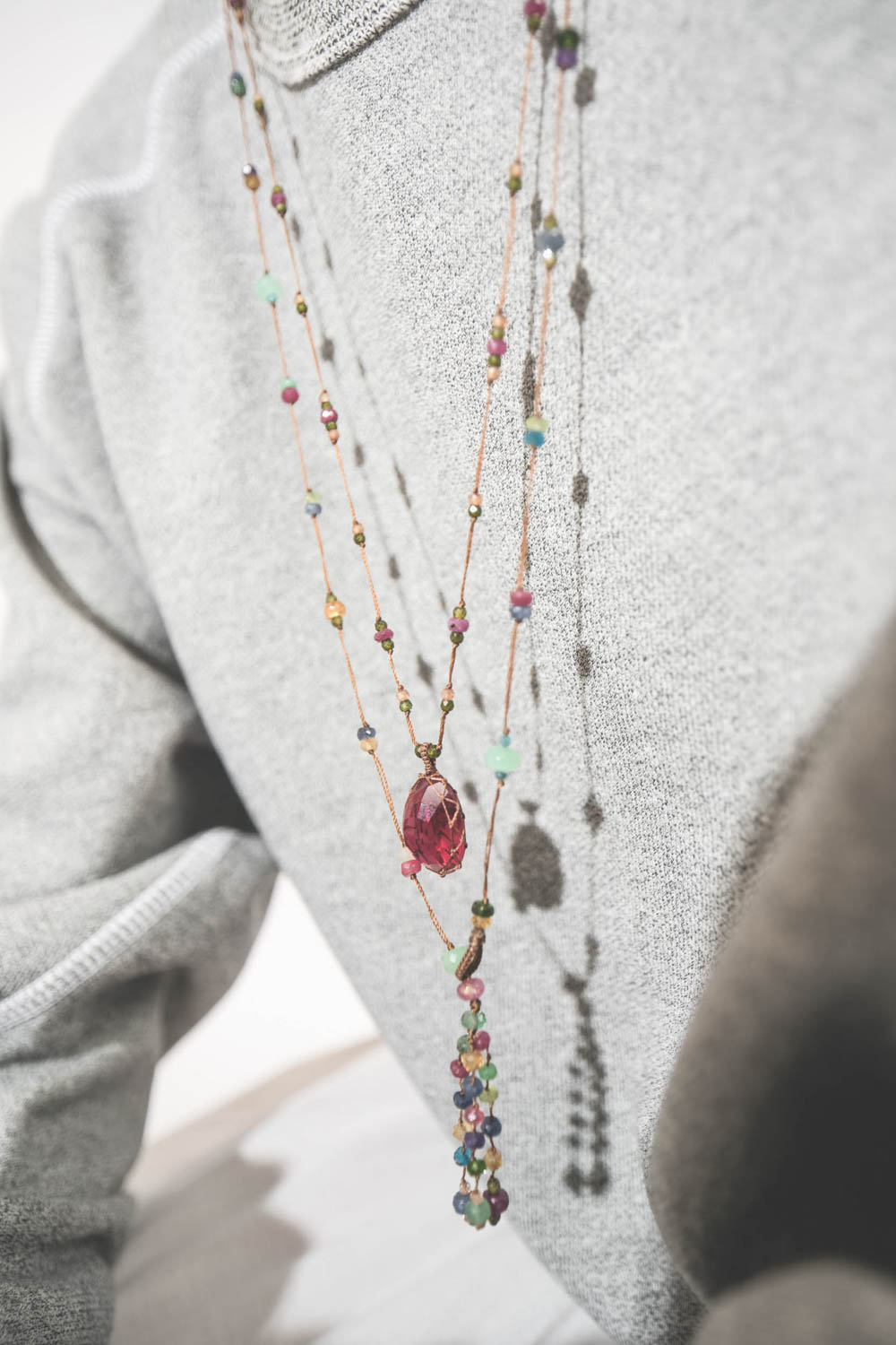 Produit Collier long Tibétain V pierre Indian Glass Red et sautoir long Holy Fairy cordon tabac Sharing bijoux. Porté en accumulation sur un sweat-shirt gris chiné College The great.