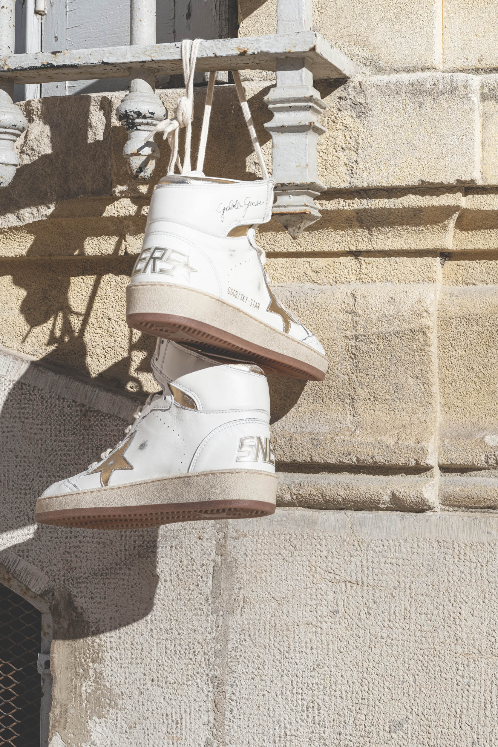 Sneakers montantes en cuir blanc &eacute;toile dor&eacute;e Sky Star Golden Goose femme. Photo d'ambiance.